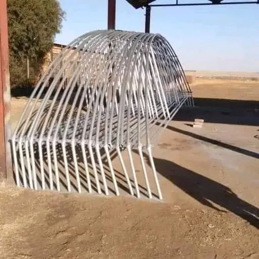 Finished steel greenhouse hoops stacked for a project